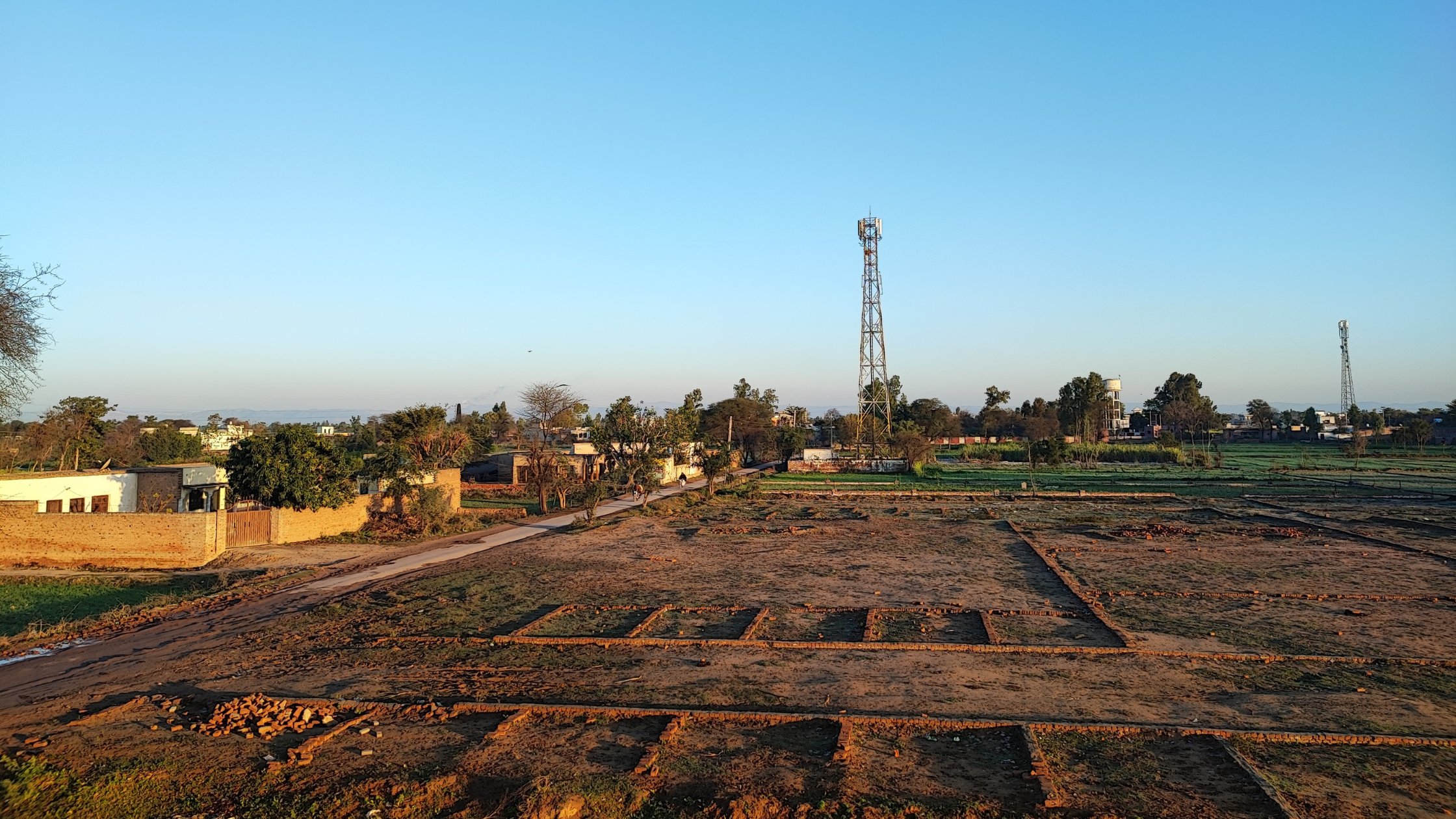 Open farmhouse plot with clear boundaries and wide road connectivity